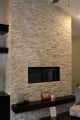 stone wall fireplace with cathedral ceiling